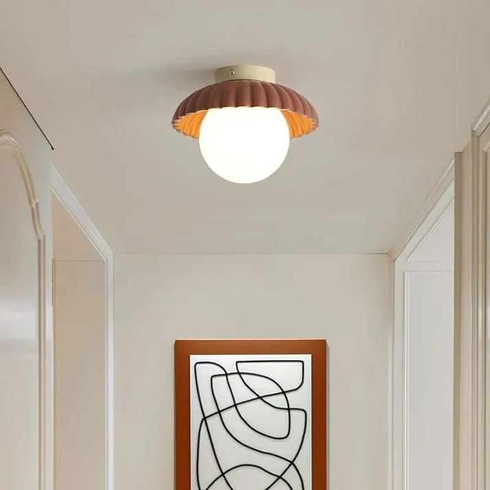 Ceiling lamp with a frosted shade providing warm lighting in the hallway