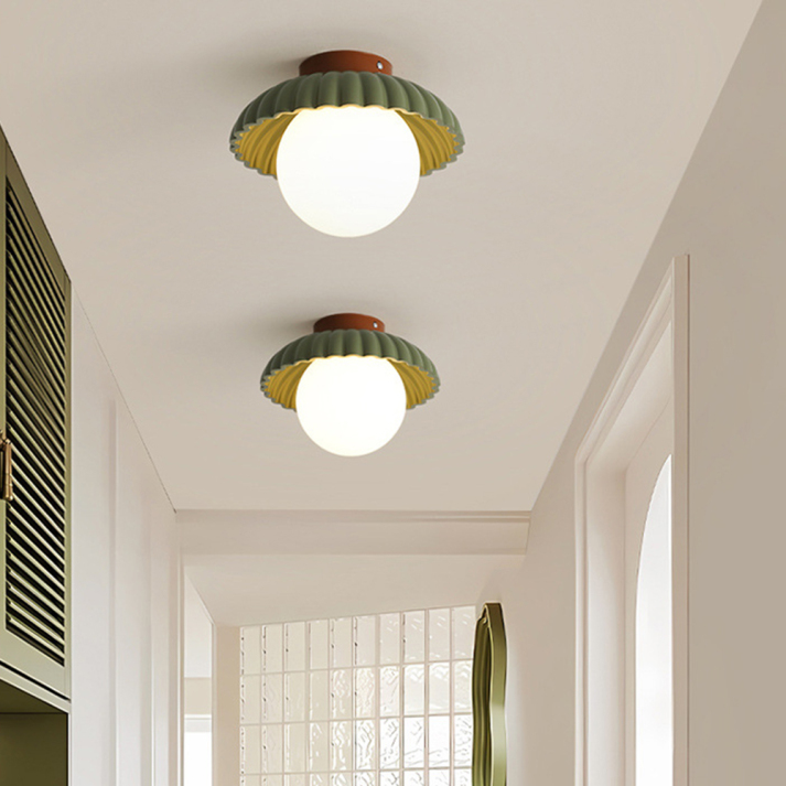 Ceiling lamp with a frosted shade providing warm lighting in the hallway